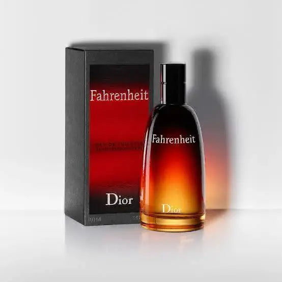 A bottle of Dior Fahrenheit Eau de Toilette fragrance next to its matching red and black product box on a plain background.